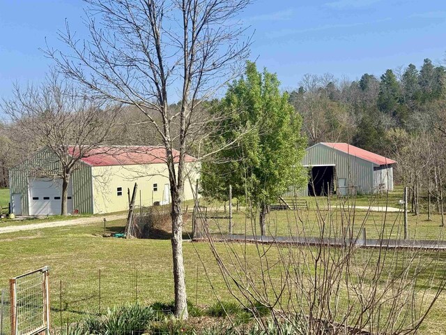2157 Pleasant Grove Rd, Wideman, AR 72585 - view of yard featuring an outbuilding, an outdoor structure, and a garage