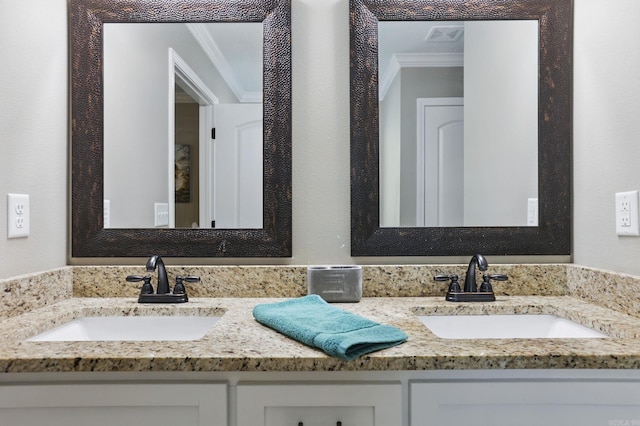 bathroom with visible vents, crown molding, and a sink