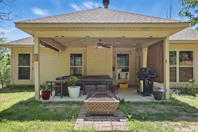 back of property featuring ceiling fan, a patio area, an outdoor living space with a fire pit, and roof with shingles