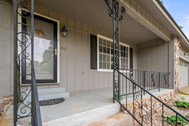 view of exterior entry with a porch