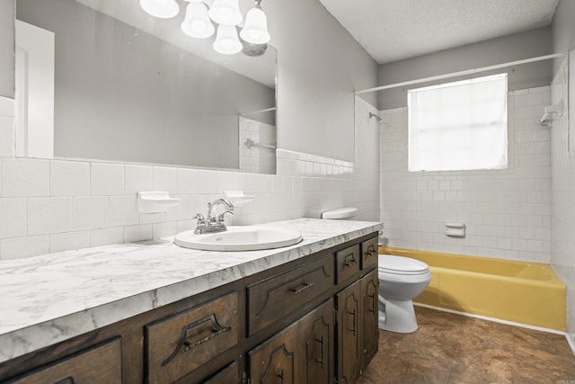 full bath with a textured ceiling, toilet, shower / bath combination, and vanity