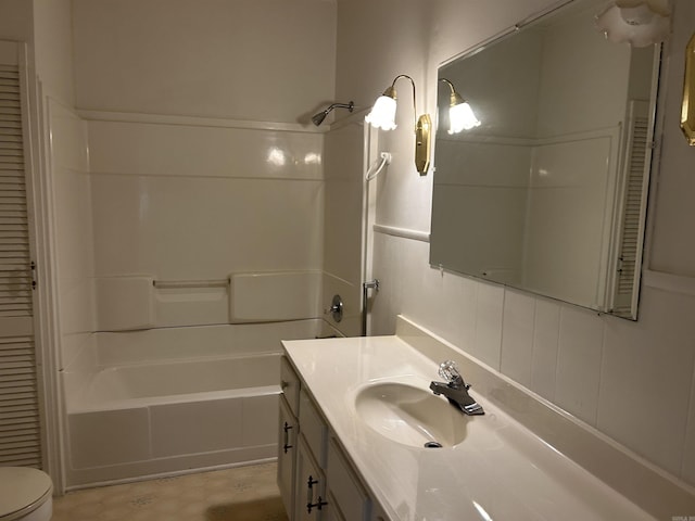 bathroom with toilet,  shower combination, and vanity