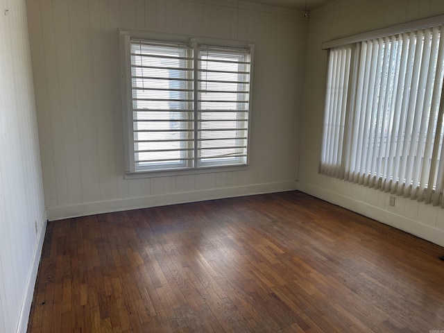 empty room featuring hardwood / wood-style floors and baseboards
