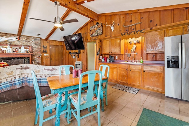 138 Ridge Rd, Houston, AR 72070 - kitchen featuring wood walls, light tile patterned floors, stainless steel fridge, and vaulted ceiling with beams