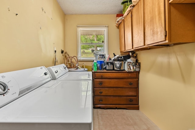 138 Ridge Rd, Houston, AR 72070 - laundry area with light tile patterned floors, washing machine and clothes dryer, cabinet space, and a textured ceiling