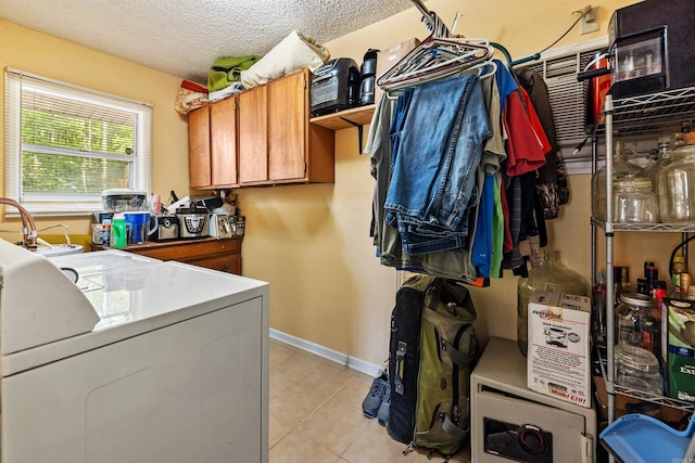 138 Ridge Rd, Houston, AR 72070 - laundry room with light tile patterned flooring, baseboards, laundry area, and a textured ceiling