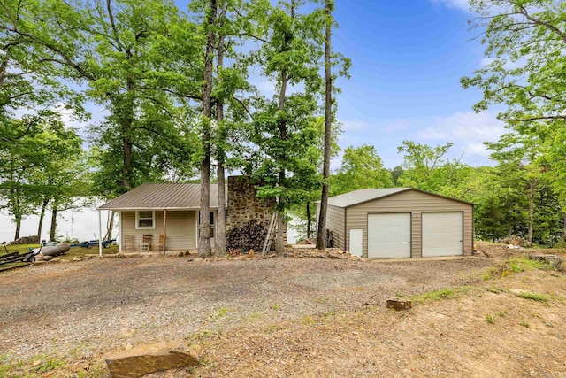 138 Ridge Rd, Houston, AR 72070 - single story home with metal roof, a detached garage, and an outbuilding