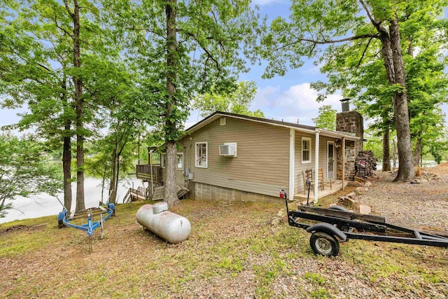 138 Ridge Rd, Houston, AR 72070 - view of side of property featuring a chimney and a wall unit AC