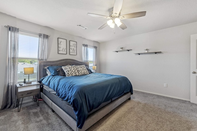bedroom featuring visible vents, a ceiling fan, carpet flooring, and baseboards