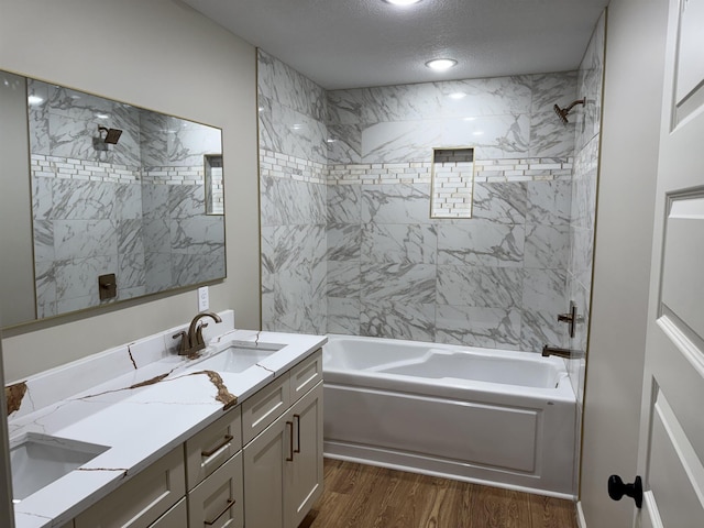 2106 N 8 1/2 St, Paragould, AR 72450 - bathroom with wood finished floors, double vanity, shower / bath combination, a sink, and a textured ceiling