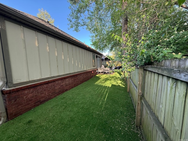 view of yard with a fenced backyard
