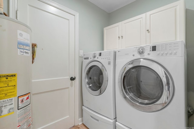 6123 Longwood, Little Rock, AR 72207 - clothes washing area featuring water heater, independent washer and dryer, and cabinet space