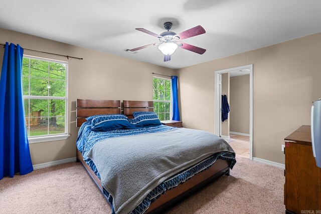 carpeted bedroom featuring visible vents, multiple windows, and baseboards