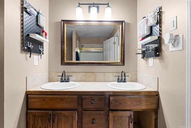 bathroom featuring double vanity and a sink