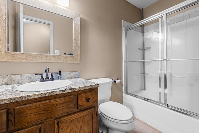 full bath featuring combined bath / shower with glass door, vanity, and toilet