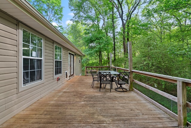 wooden terrace featuring outdoor dining space