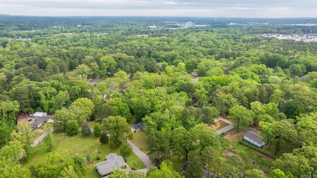 birds eye view of property featuring a view of trees