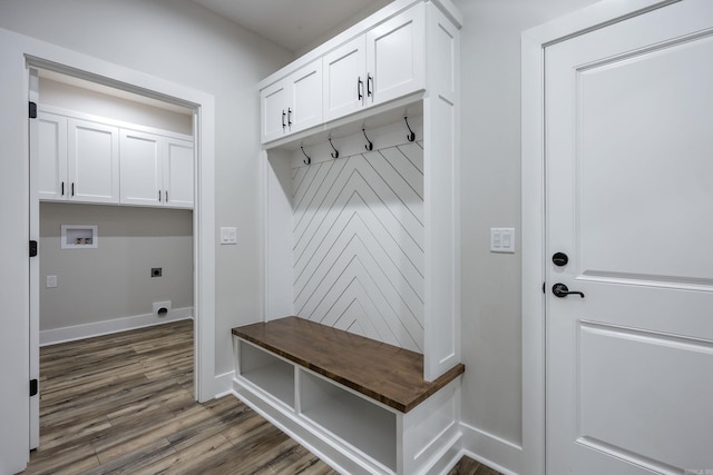 mudroom with dark wood finished floors and baseboards