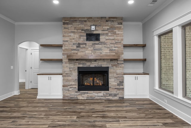 unfurnished living room featuring dark wood finished floors, visible vents, and ornamental molding