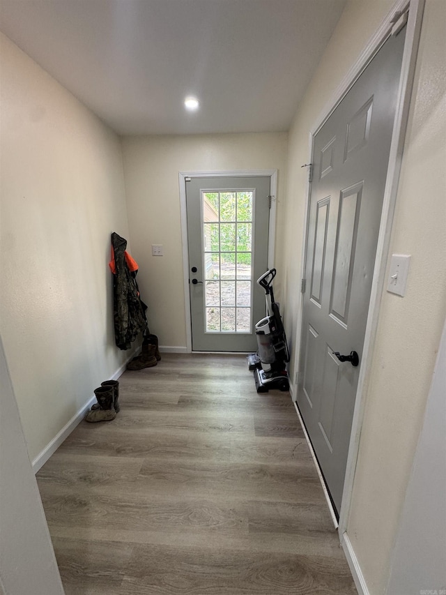 entryway with wood finished floors, recessed lighting, and baseboards