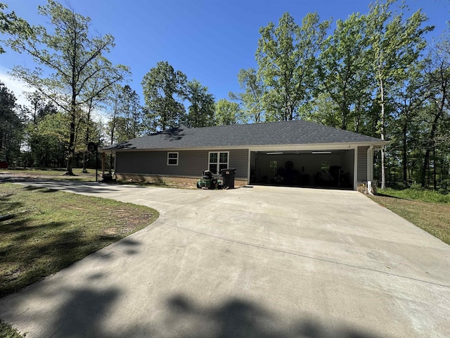 single story home featuring a garage and concrete driveway