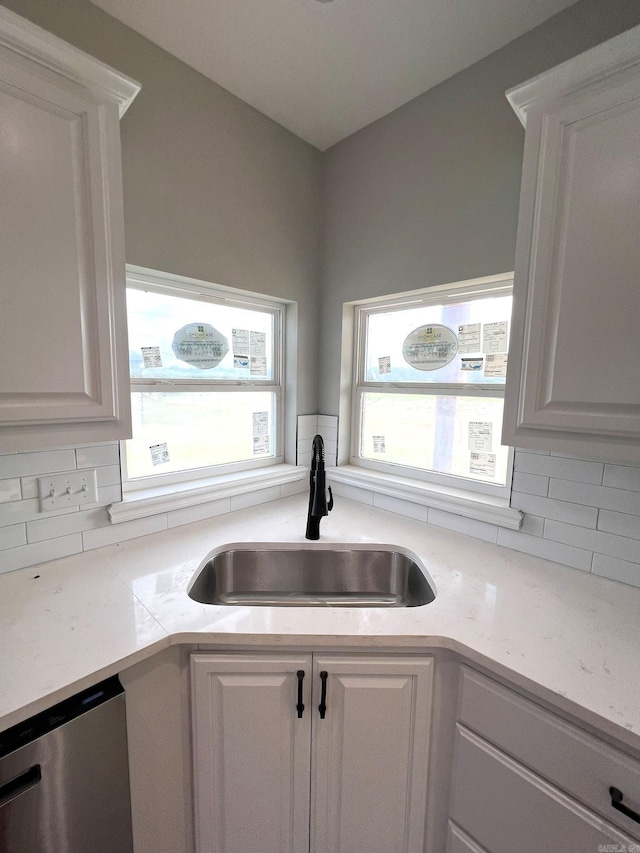 4406 Magee Dr, Texarkana, AR 71854 - kitchen with a sink, decorative backsplash, light countertops, dishwasher, and white cabinets