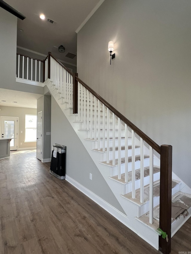 4406 Magee Dr, Texarkana, AR 71854 - stairs featuring wood finished floors, visible vents, a high ceiling, and baseboards
