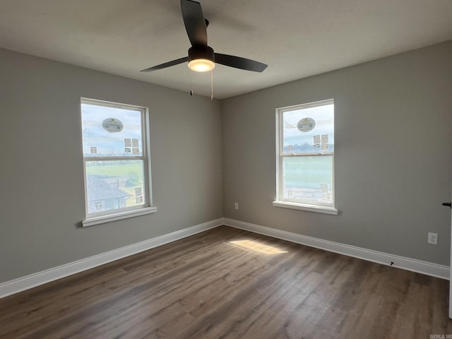 4406 Magee Dr, Texarkana, AR 71854 - spare room with dark wood-style floors, baseboards, a ceiling fan, and plenty of natural light