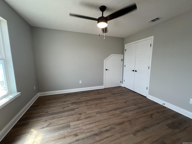 4406 Magee Dr, Texarkana, AR 71854 - unfurnished bedroom featuring a closet, a ceiling fan, visible vents, baseboards, and wood finished floors