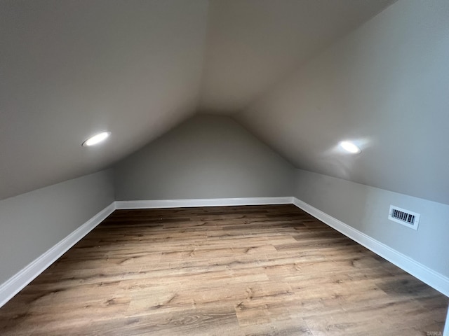 4406 Magee Dr, Texarkana, AR 71854 - bonus room featuring baseboards, visible vents, wood finished floors, and lofted ceiling