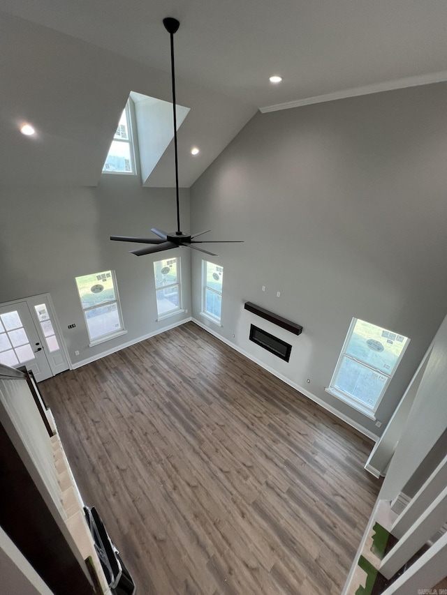 4406 Magee Dr, Texarkana, AR 71854 - unfurnished living room featuring baseboards, high vaulted ceiling, and wood finished floors