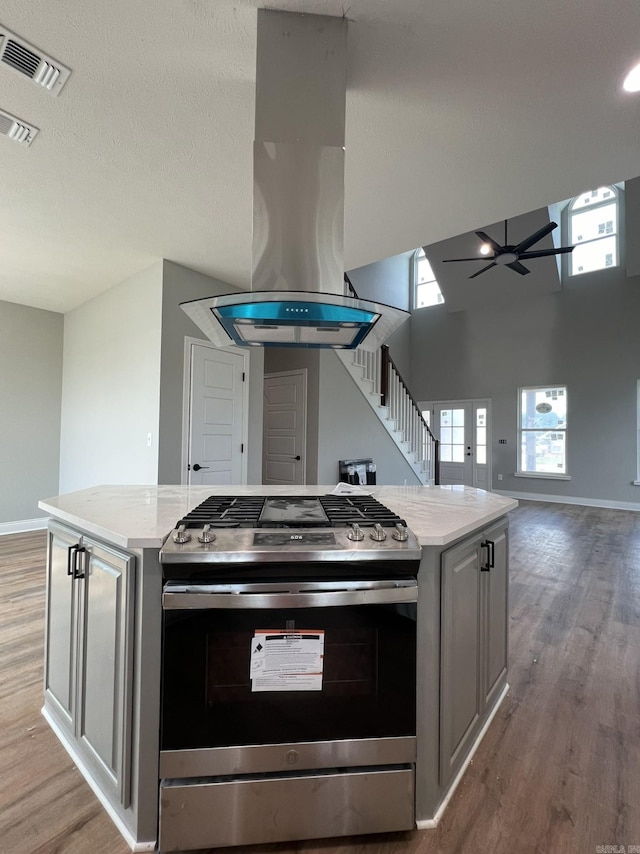 4406 Magee Dr, Texarkana, AR 71854 - kitchen with a ceiling fan, visible vents, a kitchen island, gas range, and open floor plan