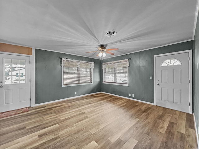 entrance foyer featuring visible vents, ceiling fan, wood finished floors, and a healthy amount of sunlight
