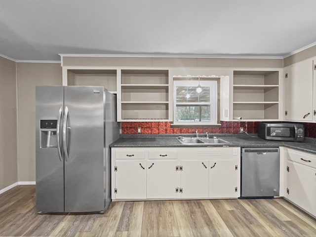 kitchen featuring ornamental molding, open shelves, and stainless steel appliances