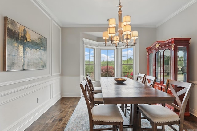 dining area with dark wood-type flooring, a chandelier, crown molding, and baseboards