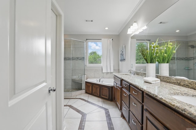 bathroom with a shower stall, double vanity, a sink, visible vents, and a garden tub