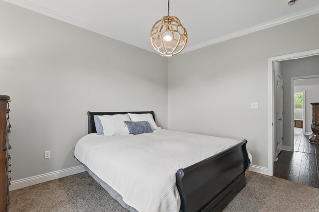 bedroom featuring ornamental molding, carpet floors, and baseboards