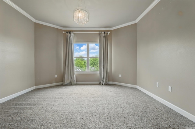 carpeted empty room featuring baseboards, ornamental molding, and an inviting chandelier