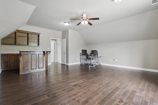 home office featuring dark wood finished floors, visible vents, ceiling fan, and lofted ceiling
