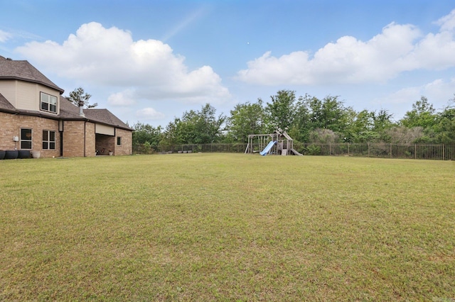 view of yard featuring a fenced backyard and a playground