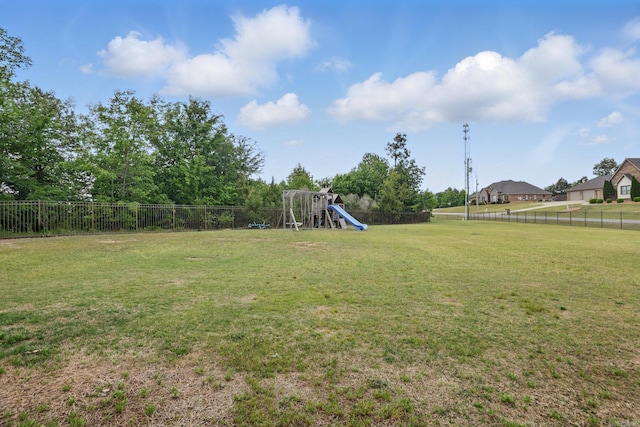 view of yard featuring a fenced backyard and a playground