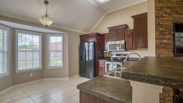 kitchen with a healthy amount of sunlight, light tile patterned floors, appliances with stainless steel finishes, dark countertops, and lofted ceiling