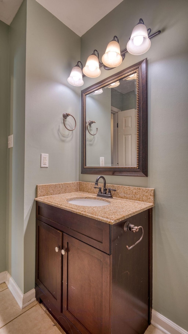 bathroom with tile patterned flooring, vanity, and baseboards