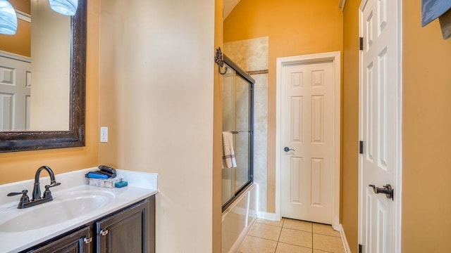 bathroom featuring tile patterned floors, shower / bath combination with glass door, and vanity