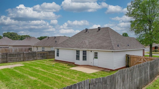 back of property with a patio, a lawn, and a fenced backyard