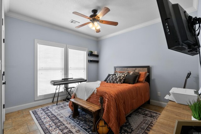bedroom featuring stone finish floor, ornamental molding, baseboards, visible vents, and a ceiling fan