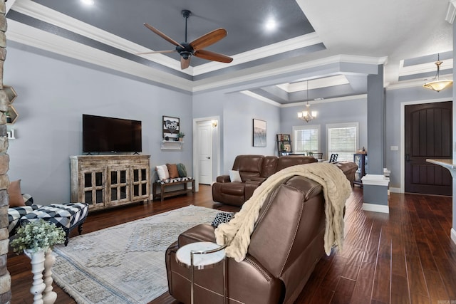living area with crown molding, a tray ceiling, dark wood finished floors, and ceiling fan with notable chandelier