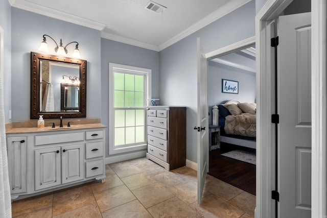 bathroom with crown molding, visible vents, vanity, and baseboards