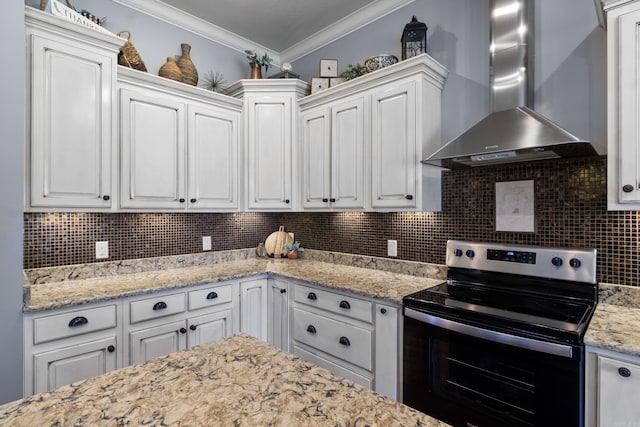 kitchen featuring white cabinetry, stainless steel electric stove, crown molding, and wall chimney range hood