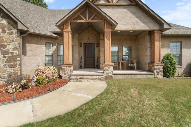 property entrance featuring a porch, a lawn, stone siding, and a shingled roof